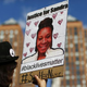 A woman at a Michael Brown memorial rally in Union Square in New York City on Aug. 9, 2015, holds a poster bearing the portrait of Sandra Bland, who killed herself in a Texas jail cell July 13, 2015.
KENA BETANCUR/AFP/Getty Images